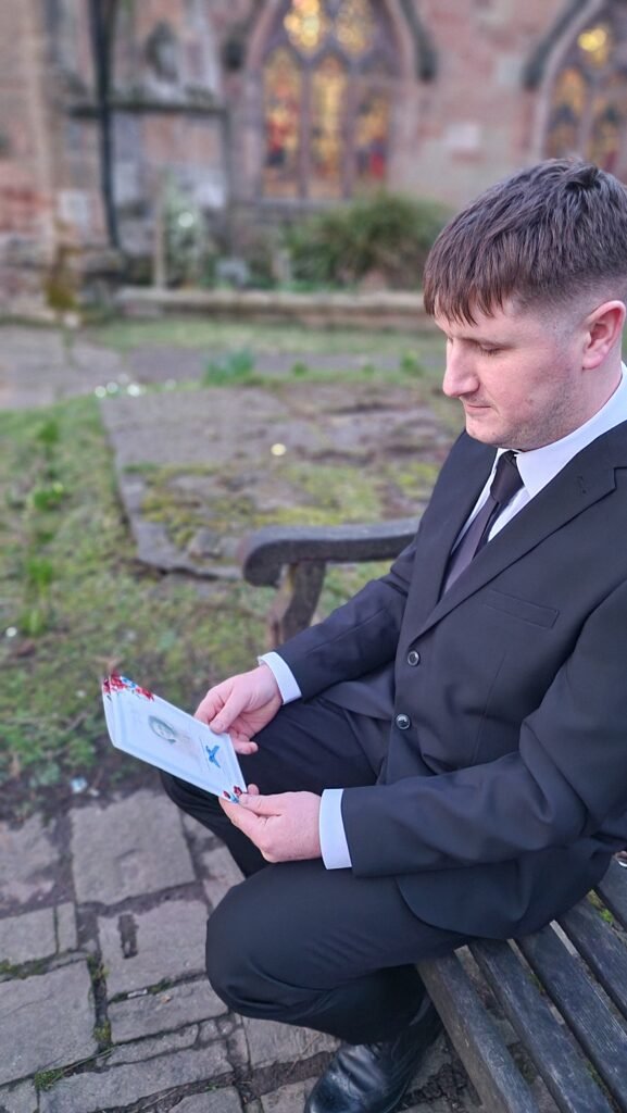 Loved one holding Order of Service designed by Dove and Lilly